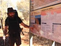 Guide Ryan giving a daily briefing using the Larapinta Trail park maps. |  <i>Ayla Rowe</i>