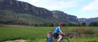 Cyclist passing the impressive escarpment of the Capertee Valley | Ross Baker