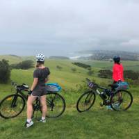 Cyclists soaking up the view of the coastline between Kiama and Gerroa | Kate Baker