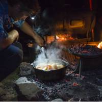 The Larapinta Guides still cook with traditional camp ovens over an open fire | Caroline Crick