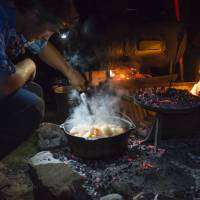 The Larapinta Guides still cook with traditional camp ovens over an open fire | Caroline Crick