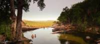 Relaxing in the waterhole above Gunlom Waterfall on the Kakadu Walking Adventure | Rhys Clarke