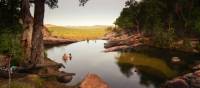 Relaxing in the waterhole above Gunlom Waterfall on the Kakadu Walking Adventure | Rhys Clarke