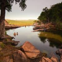 Relaxing in the waterhole above Gunlom Waterfall on the Kakadu Walking Adventure | Rhys Clarke