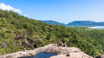 Thorsborne Trail trekkers resting beside a rock pool on Hinchinbrook Island | Eloise Weston