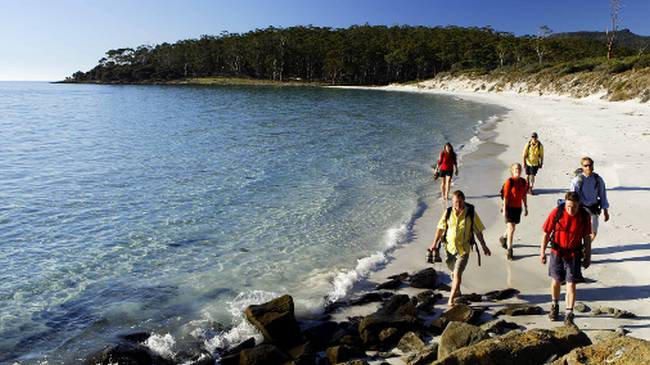 Walkers on 4 Mile Beach on Maria Island