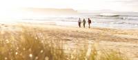 A couple walking on the beach on Bruny Island