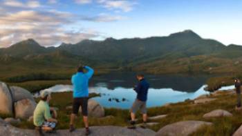 Hikers taking in the breathtaking views of Cradle Mountain and Lake St Clair