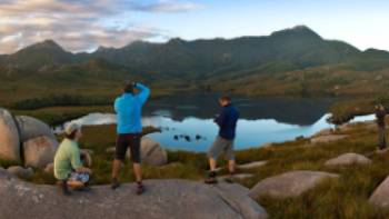Hikers taking in the breathtaking views of Cradle Mountain and Lake St Clair