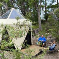Hikers putting up their feet at our coastal Eco-Comfort Camp | Michael Buggy