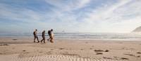 Guests walk along Stephens Bay, a remote beach | Mark Daffey