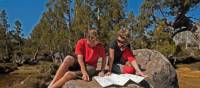 Enjoying the sunshine, reading maps on a Tasmanian Expeditions trek | Don Fuchs