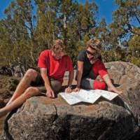 Enjoying the sunshine, reading maps on a Tasmanian Expeditions trek | Don Fuchs