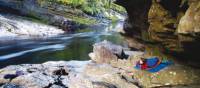 Camping under a rock shelter at Newland's Cascade on the Franklin River | Carl Roe