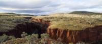 Wander down into ancient deep gorges of layered red rock at Karijini National Park | Tourism Western Australia