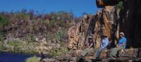 Hikers sitting on a rock edge | Tim Macartney-Snape