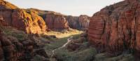 Embark on an exhilarating trek through the rugged terrain of Piccaninny Creek bed, immersing yourself in the exploration of the remote and spectacular gorge network. | Tourism Western Australia