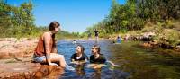 Kids cooling off during a walk in Kakadu National Park | Tourism NT/Shaana McNaught