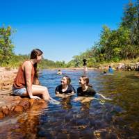 Kids cooling off during a walk in Kakadu National Park | Tourism NT/Shaana McNaught