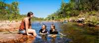 Kids cooling off during a walk in Kakadu National Park | Tourism NT/Shaana McNaught
