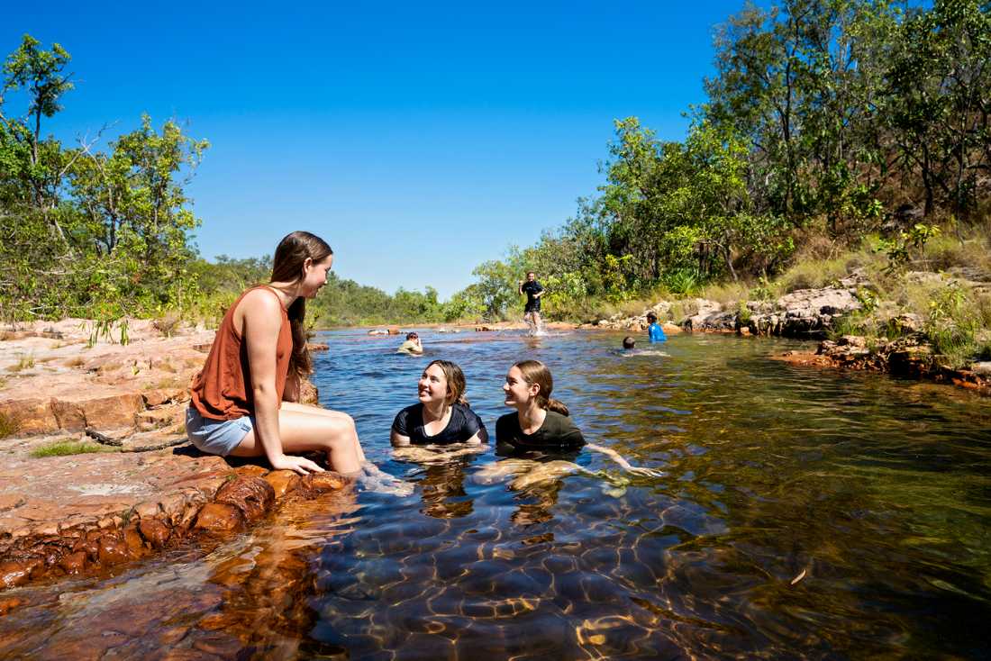 Kids cooling off during a walk in Kakadu National Park |  Tourism NT/Shaana McNaught