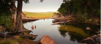 Relaxing in the waterhole above Gunlom Waterfall | Rhys Clarke